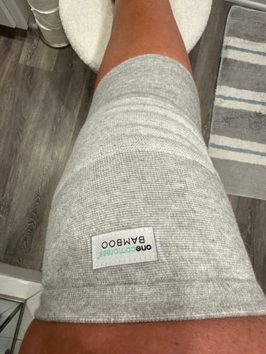 Customer wearing the grey, textured Premium Bamboo Knee Sleeve on their leg.