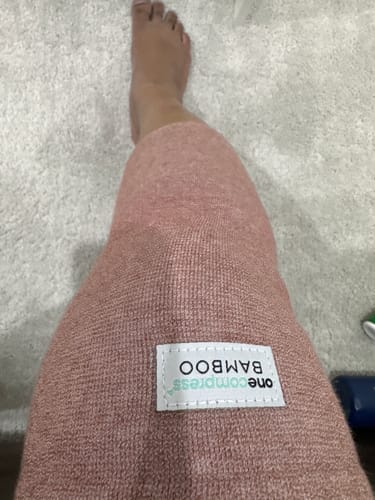 Customer wearing the textured, pinkish Premium Bamboo Knee Sleeve on their leg.