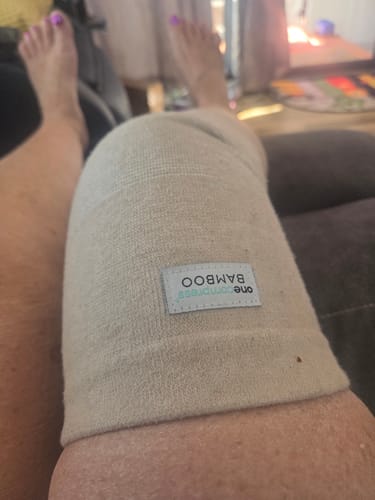 Customer resting with the Premium Bamboo Knee Sleeve on their knee.